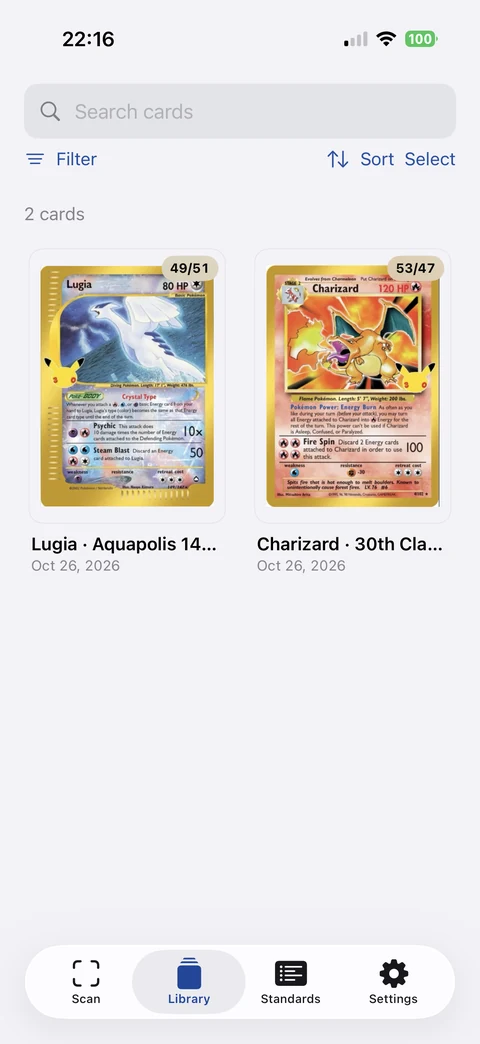 CardGrader Library showing photographed Lugia and Charizard cards with centering badges, search, Filter, Sort and Select controls.